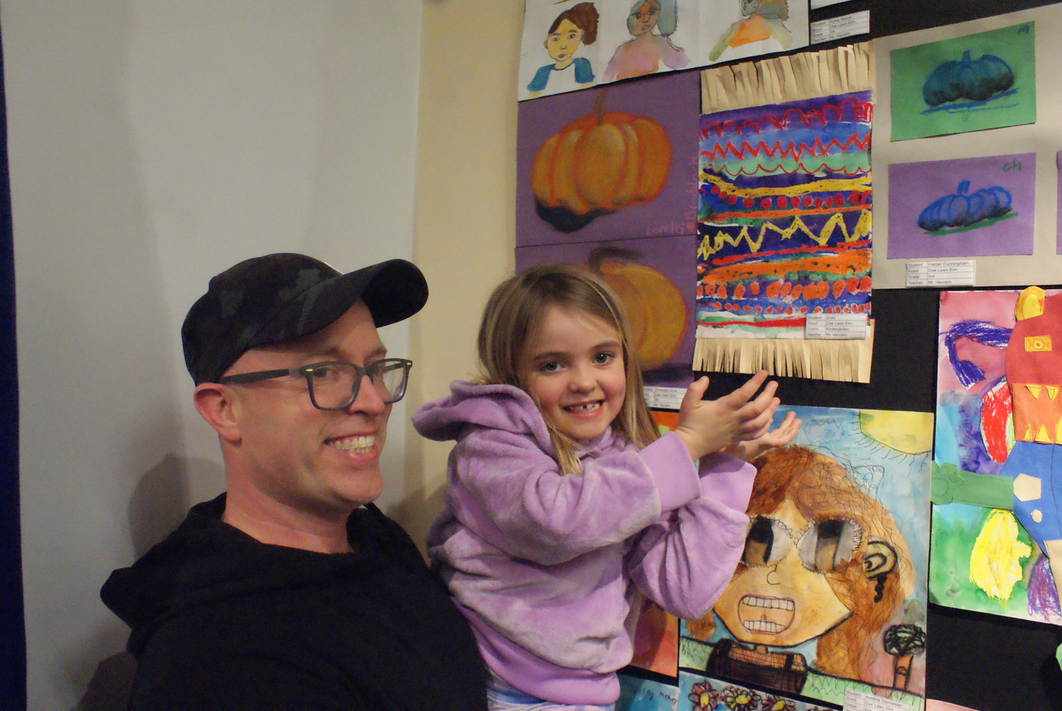 THE ART OF YOUTH: Zoey Tanguay , a 5 year old Kindergarten student at Oaklawn Elementary School proudly shows us her artwork, with the help of her dad Justin.